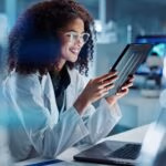 Tablet,,Laptop,And,Woman,Scientist,In,Lab,Working,On,Medical
