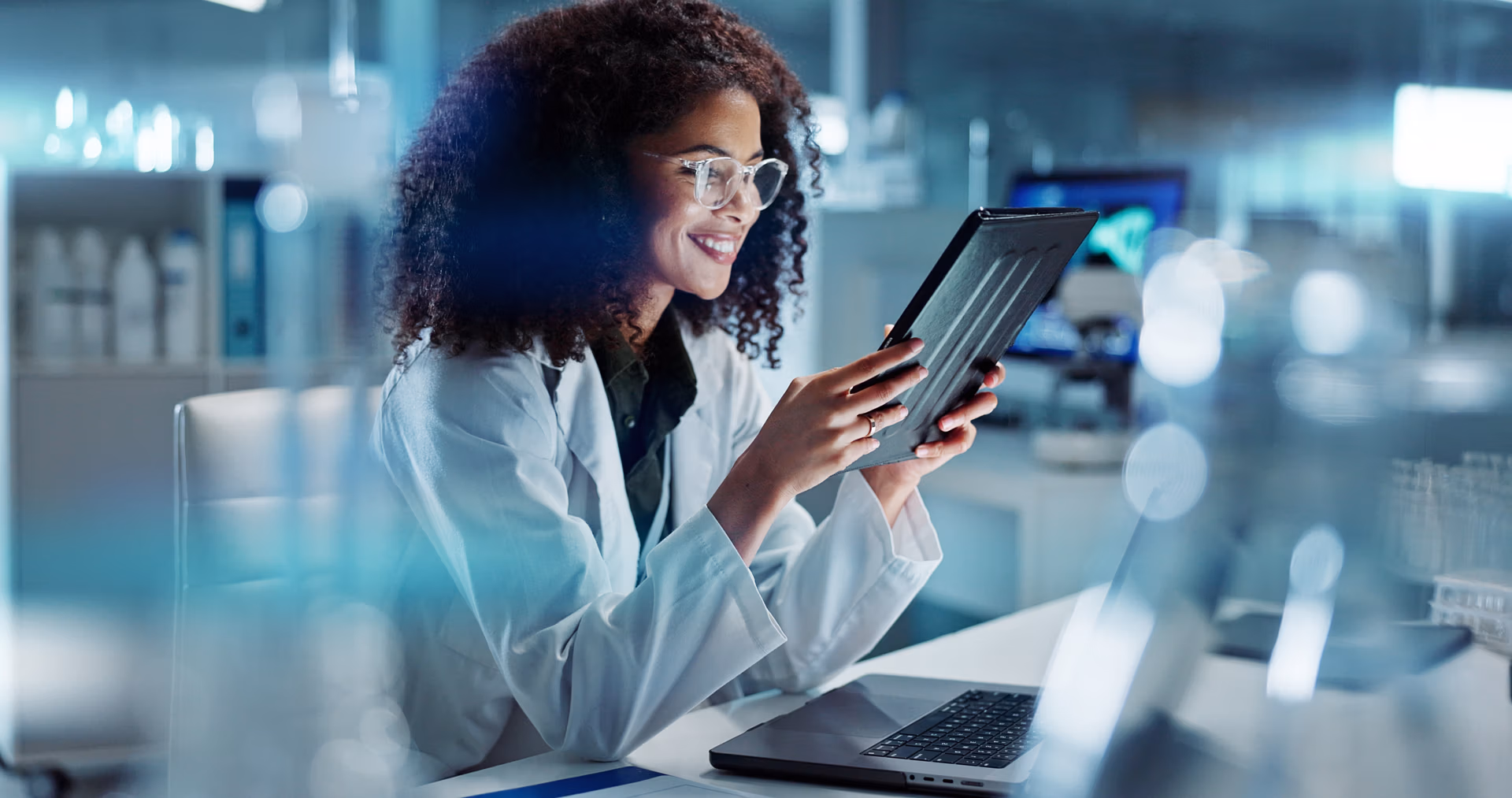 Tablet,,Laptop,And,Woman,Scientist,In,Lab,Working,On,Medical Tablet,,Laptop,And,Woman,Scientist,In,Lab,Working,On,Medical