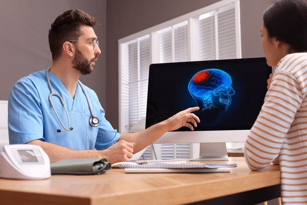 Neurologist,Showing,Brain,Scan,To,Young,Woman,In,Clinic Neurologist,Showing,Brain,Scan,To,Young,Woman,In,Clinic
