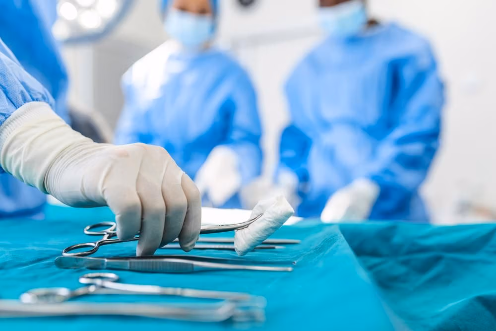 Nurse,Hand,Taking,Surgical,Instrument,For,Group,Of,Surgeons,At Nurse,Hand,Taking,Surgical,Instrument,For,Group,Of,Surgeons,At