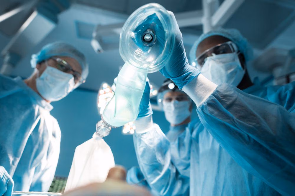 Bottom,View,Of,African,American,Anesthetist,Holding,Oxygen,Mask,Above Bottom,View,Of,African,American,Anesthetist,Holding,Oxygen,Mask,Above