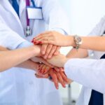 Doctors,And,Nurses,In,A,Medical,Team,Stacking,Hands