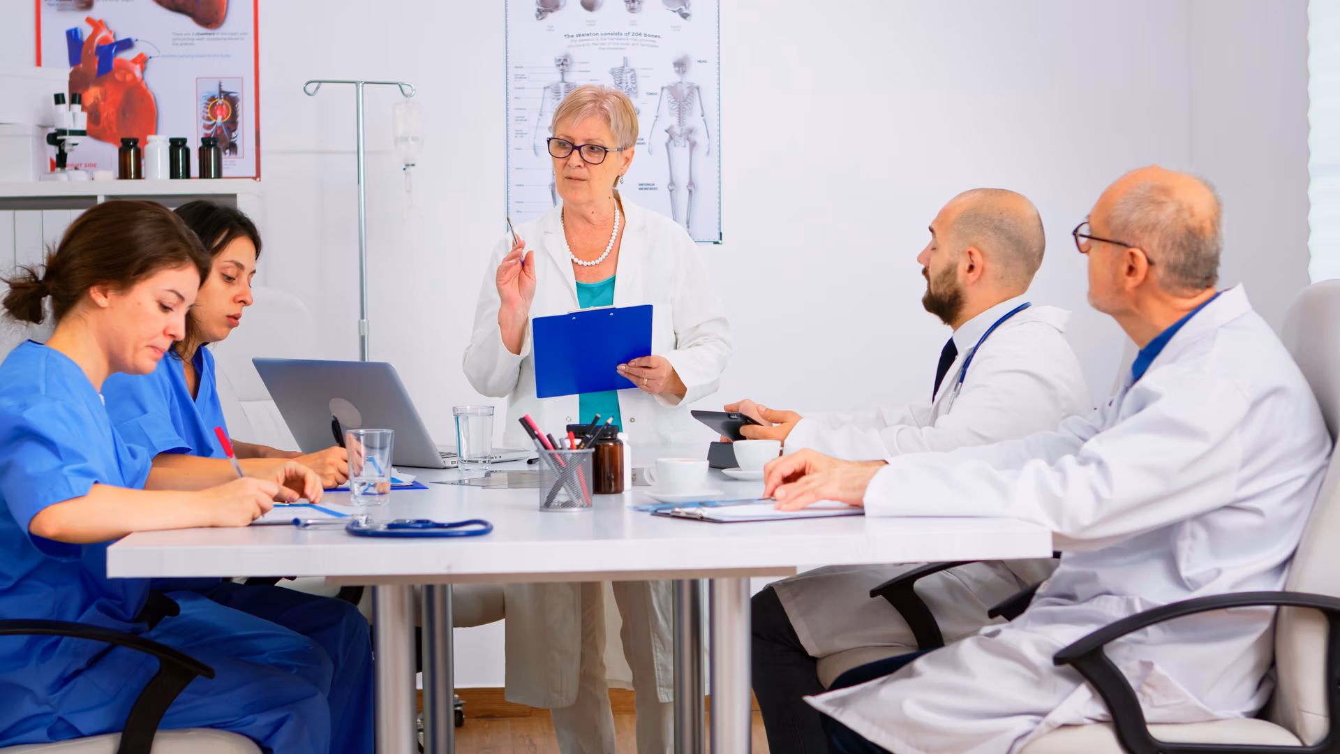 Portrait,Of,Mature,Woman,Doctor,Heading,Committee,Meeting,At,Medical Portrait,Of,Mature,Woman,Doctor,Heading,Committee,Meeting,At,Medical