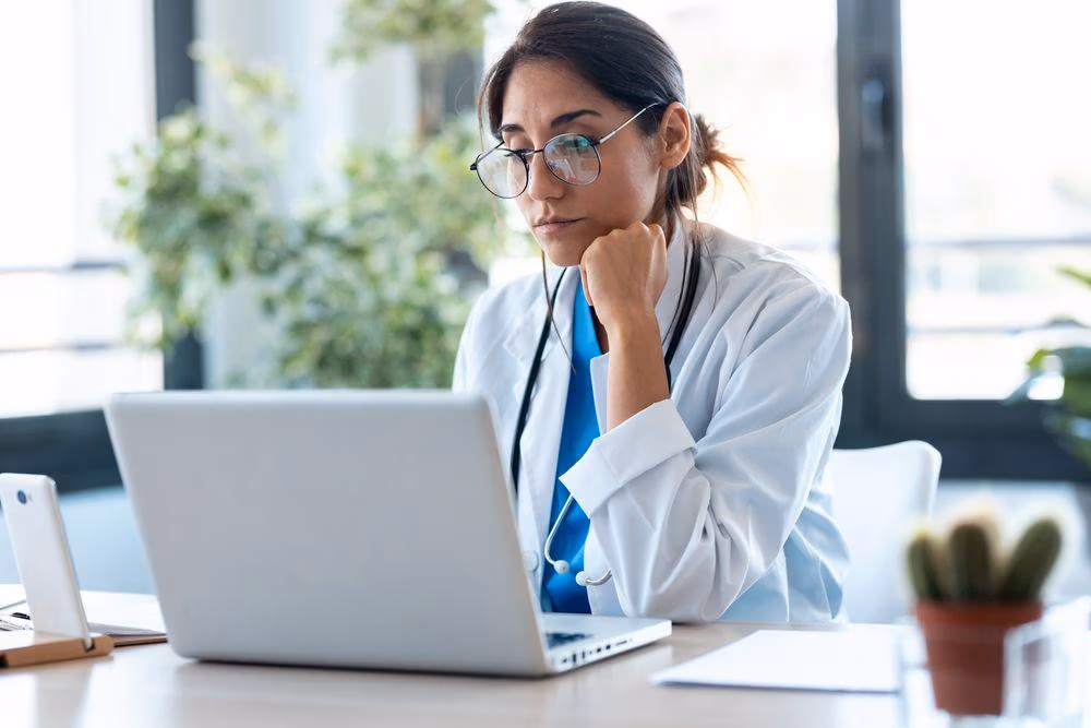 Shot,Of,Serious,Female,Doctor,Working,With,Her,Laptop,In Shot,Of,Serious,Female,Doctor,Working,With,Her,Laptop,In