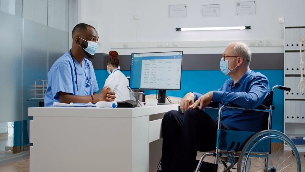 Male,Nurse,Doing,Checkup,Consultation,With,Elderly,Man,In,Wheelchair, Male,Nurse,Doing,Checkup,Consultation,With,Elderly,Man,In,Wheelchair,