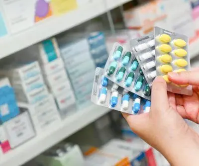 Hand,Holding,Medicine,Capsule,Pack,At,The,Pharmacy,Drugstore. Hand,Holding,Medicine,Capsule,Pack,At,The,Pharmacy,Drugstore.