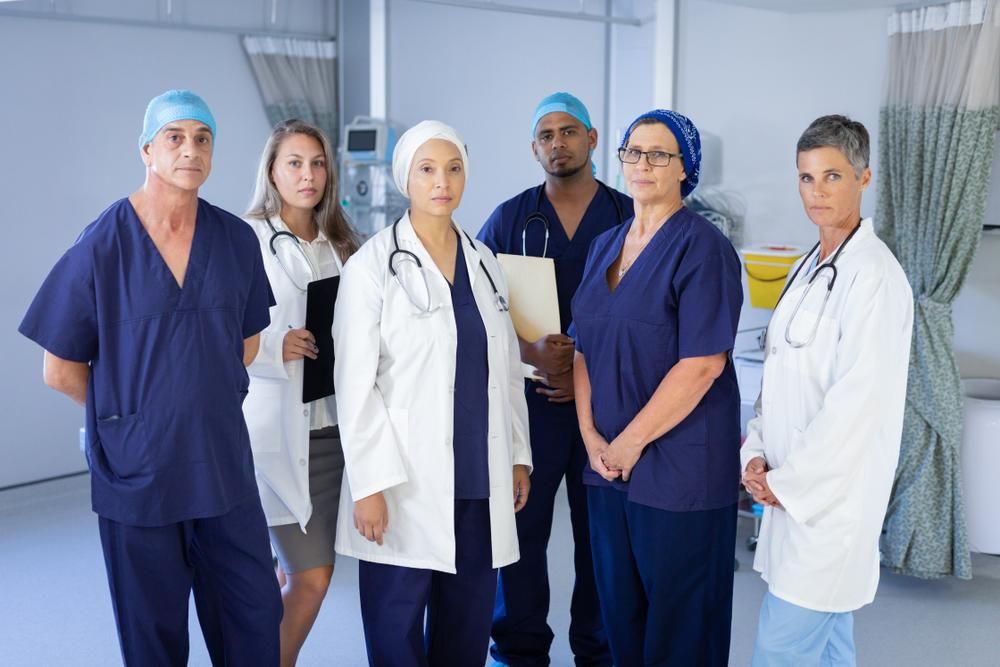 Portrait,Of,Serious,Multi-ethnic,Doctors,And,Surgeons,Looking,At,The