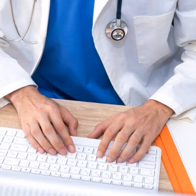 Doctor's,Hands,Typing,In,The,Computer