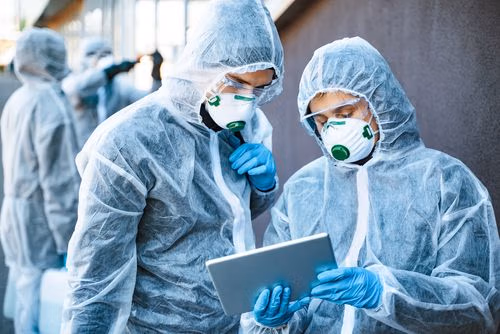Healthcare,Workers,Wearing,Hazmat,Suits,Working,Together,To,Control,An
