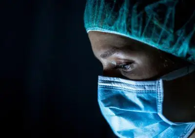 Portrait,Of,Young,Female,Surgeon,,Wearing,Mask,And,A,Surgical Portrait,Of,Young,Female,Surgeon,,Wearing,Mask,And,A,Surgical