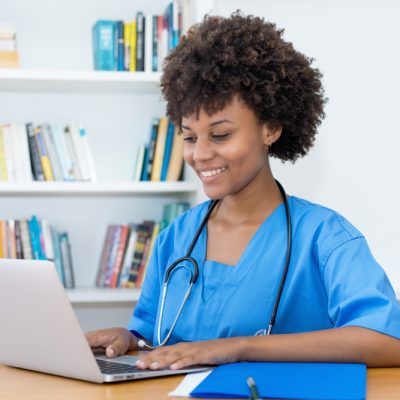 Working,Afro,American,Nurse,Or,Medical,Student,At,Computer,At