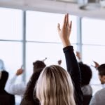 Conference,,Crowd,And,Business,People,With,Hands,For,A,Question,