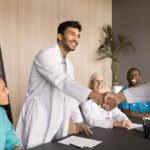 Happy,Young,Indian,Male,Doctor,Giving,Handshake,To,Cooperation,Partner,