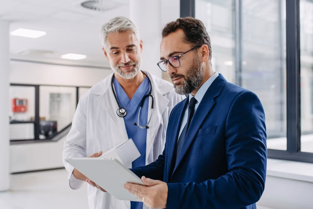 Pharmaceutical,Sales,Representative,Talking,With,Doctor,In,Medical,Building,,Presenting Pharmaceutical,Sales,Representative,Talking,With,Doctor,In,Medical,Building,,Presenting