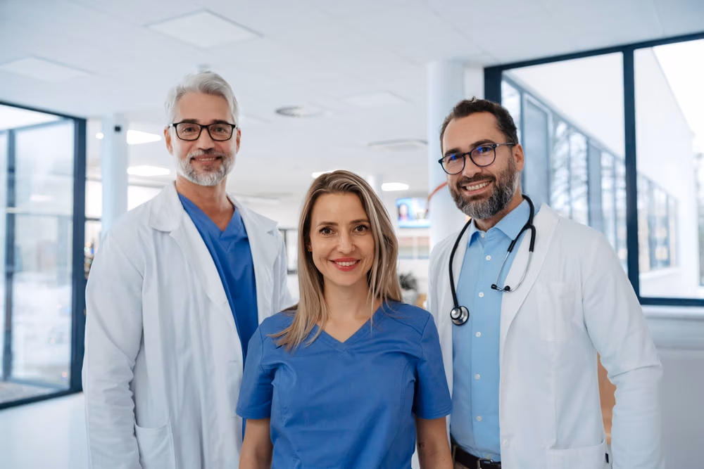 Portrait,Of,Confident,Three,Doctors,Standing,In,Hospital,Corridor.,Medical Portrait,Of,Confident,Three,Doctors,Standing,In,Hospital,Corridor.,Medical
