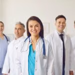 Portrait,Of,A,Happy,Woman,Doctor,Standing,With,A,Team